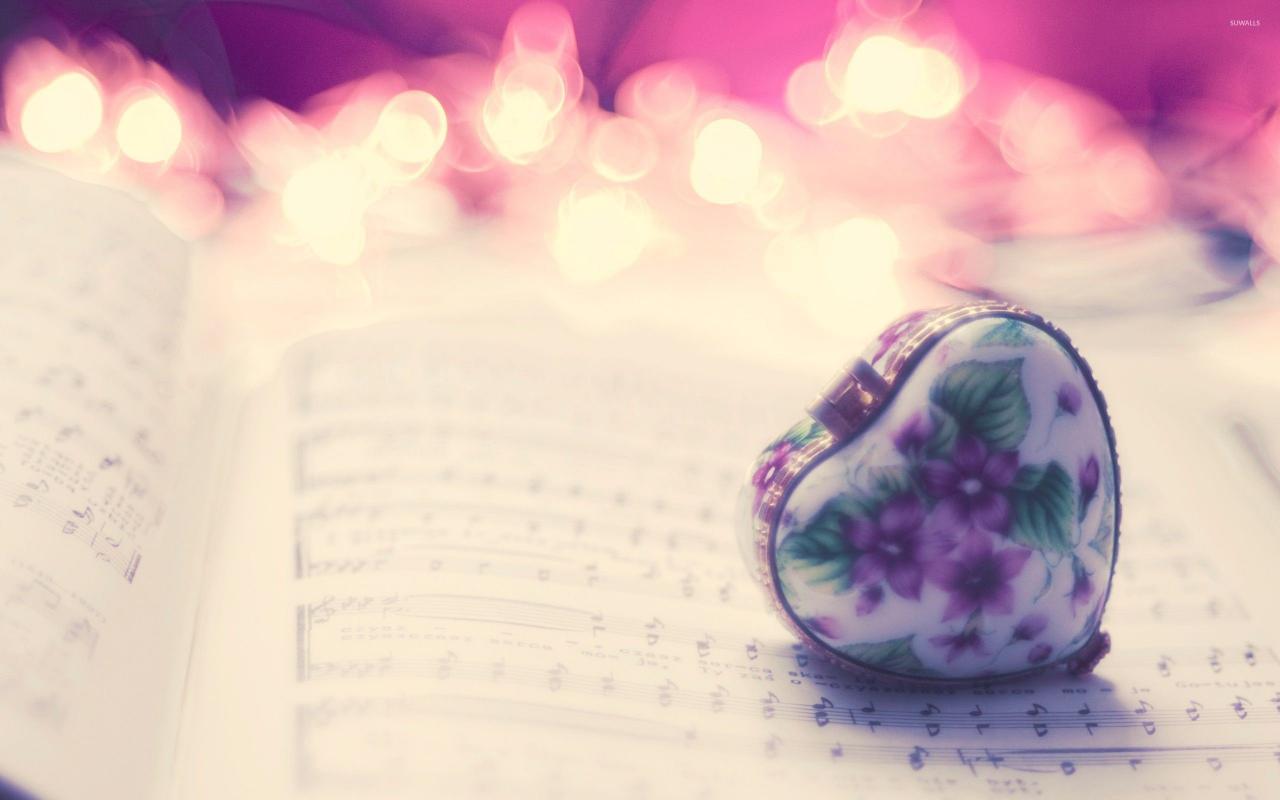 2560x1600 Heart pendant over music sheet wallpaper